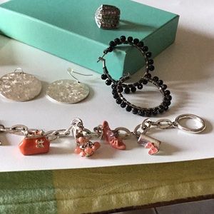 4 piece costume jewelry set. 2 pr earrings, 1 ring and 1 charm bracelet.